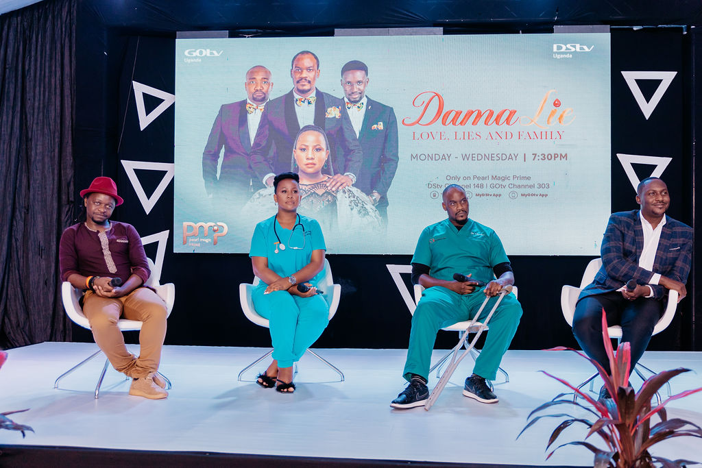 Four people seated on stage in front of a large screen displaying the promo poster for 'Dama Lie: Love, Lies and Family' TV show airing Monday to Wednesday at 7:30 PM on GOtv and DStv Uganda.