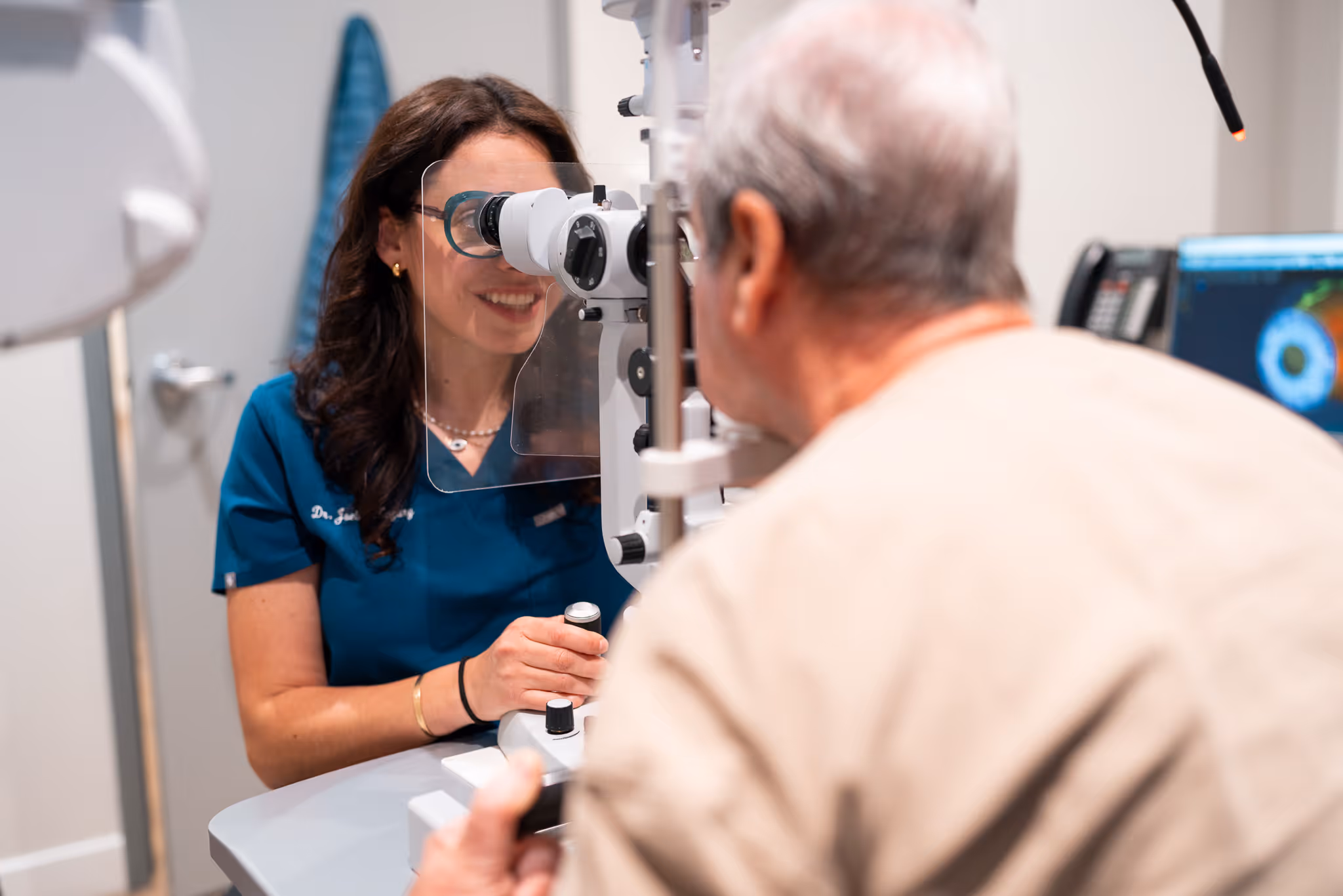 Dr. Joelle Zagury of Vision Care Merivale conducting an eye exam on a patient