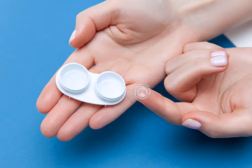 Contact Lenses. Two hands holding contact lens case and  contact lens on finger.