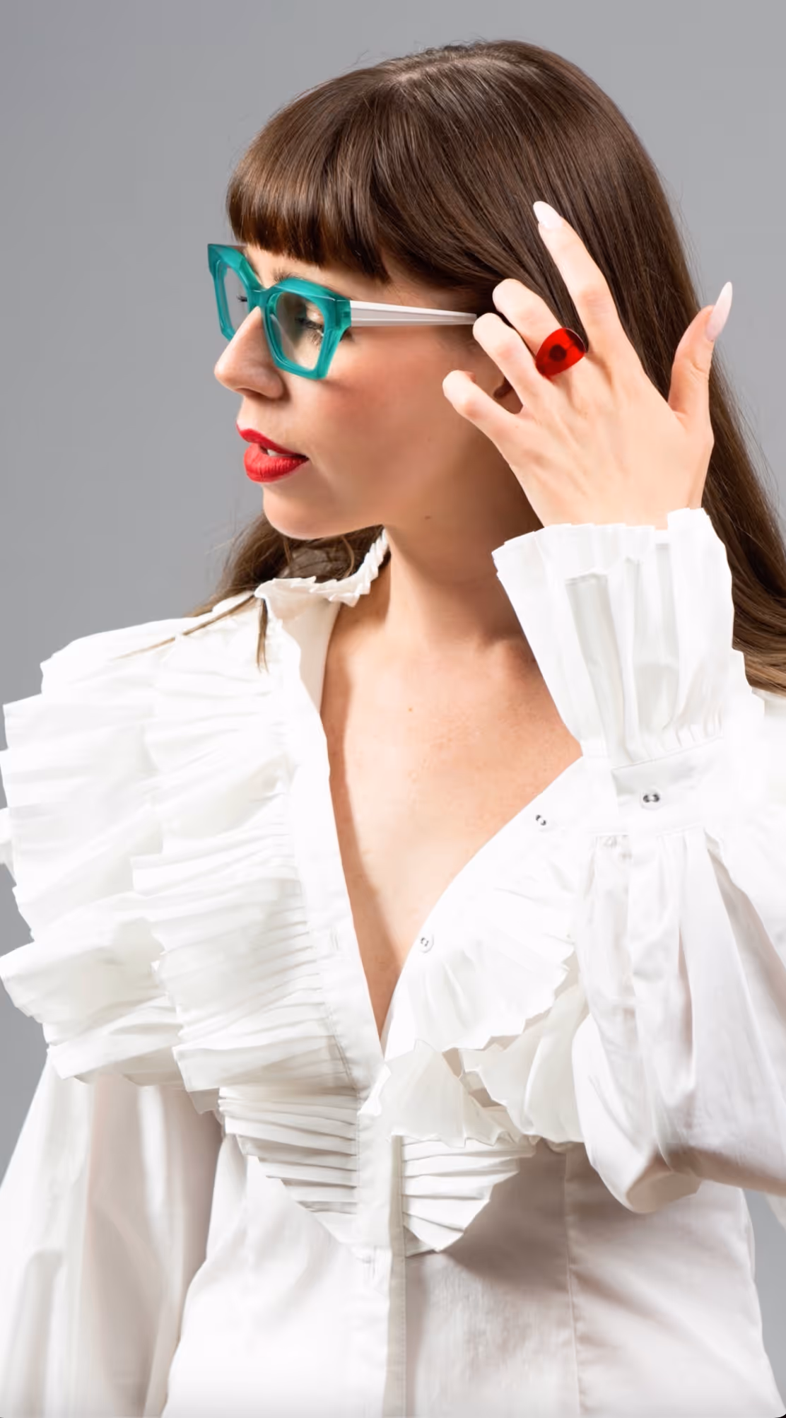 woman wearing white and turquoise eyewear frame