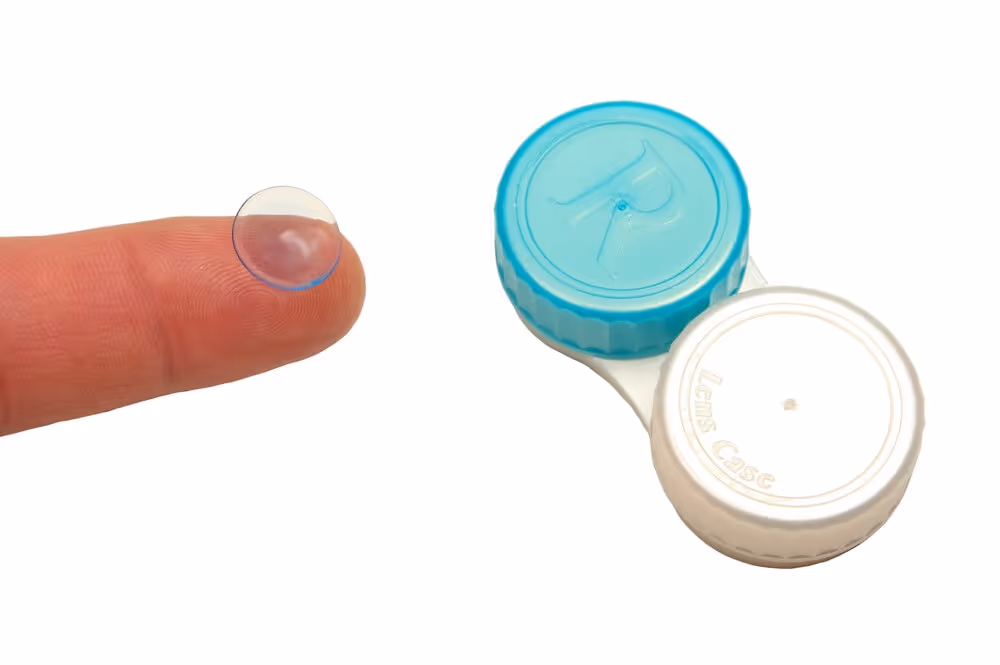 Toric Contact Lenses. Finger with contact lens.