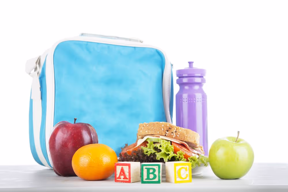 Backpack Drive in support of the Boys and Girls Club of Ottawa (BGC).  Closeup of a packed school lunch with alphabet blocks.