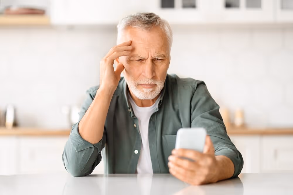Contact Lenses needed for elderly man squinting eyes to read.