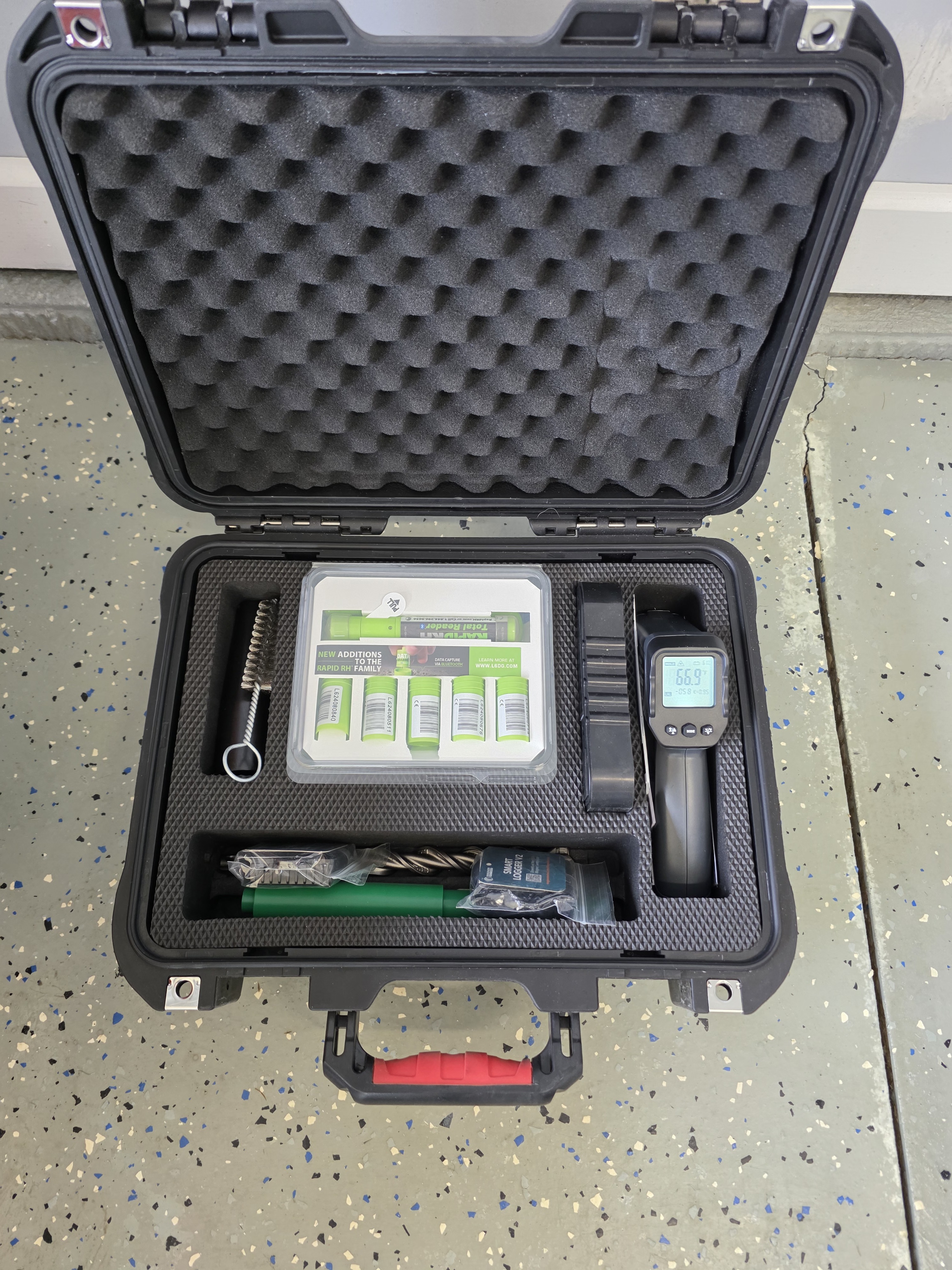 Concrete moisture meter positioned on a prepared industrial floor slab