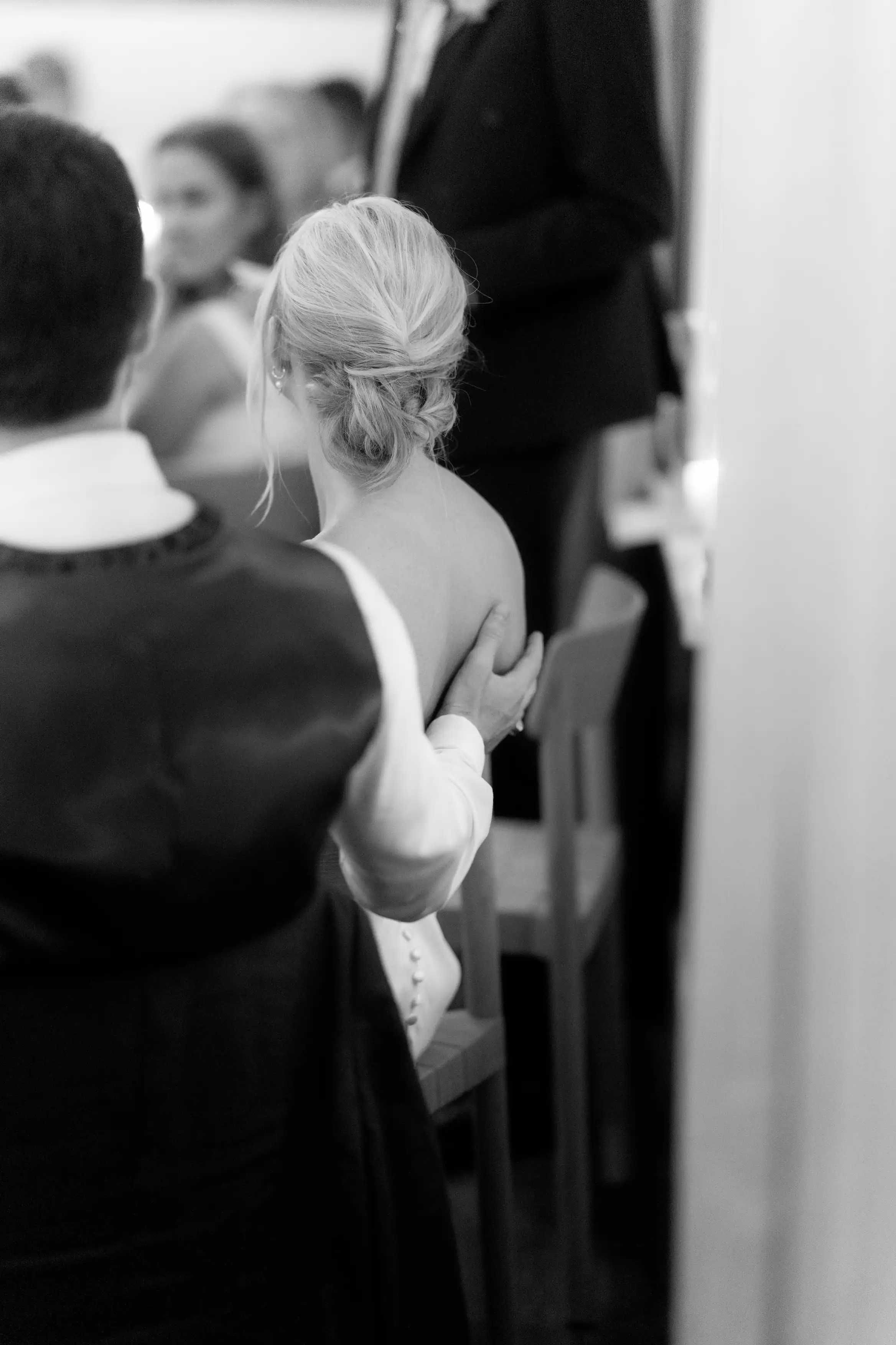 An intimate picture of the bride and groom listening to a speech