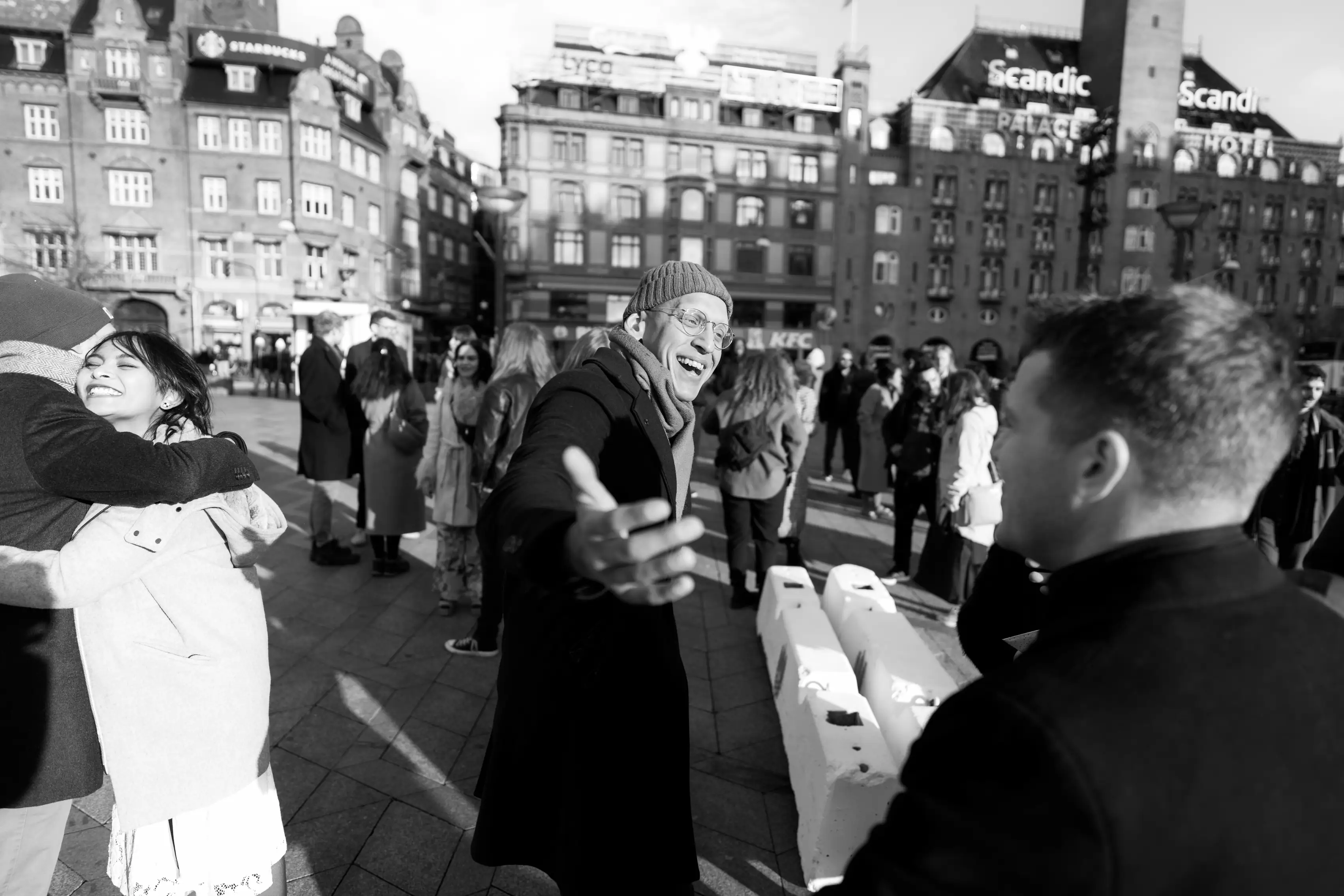 Wedding goers meeting and gretting each other in a town square