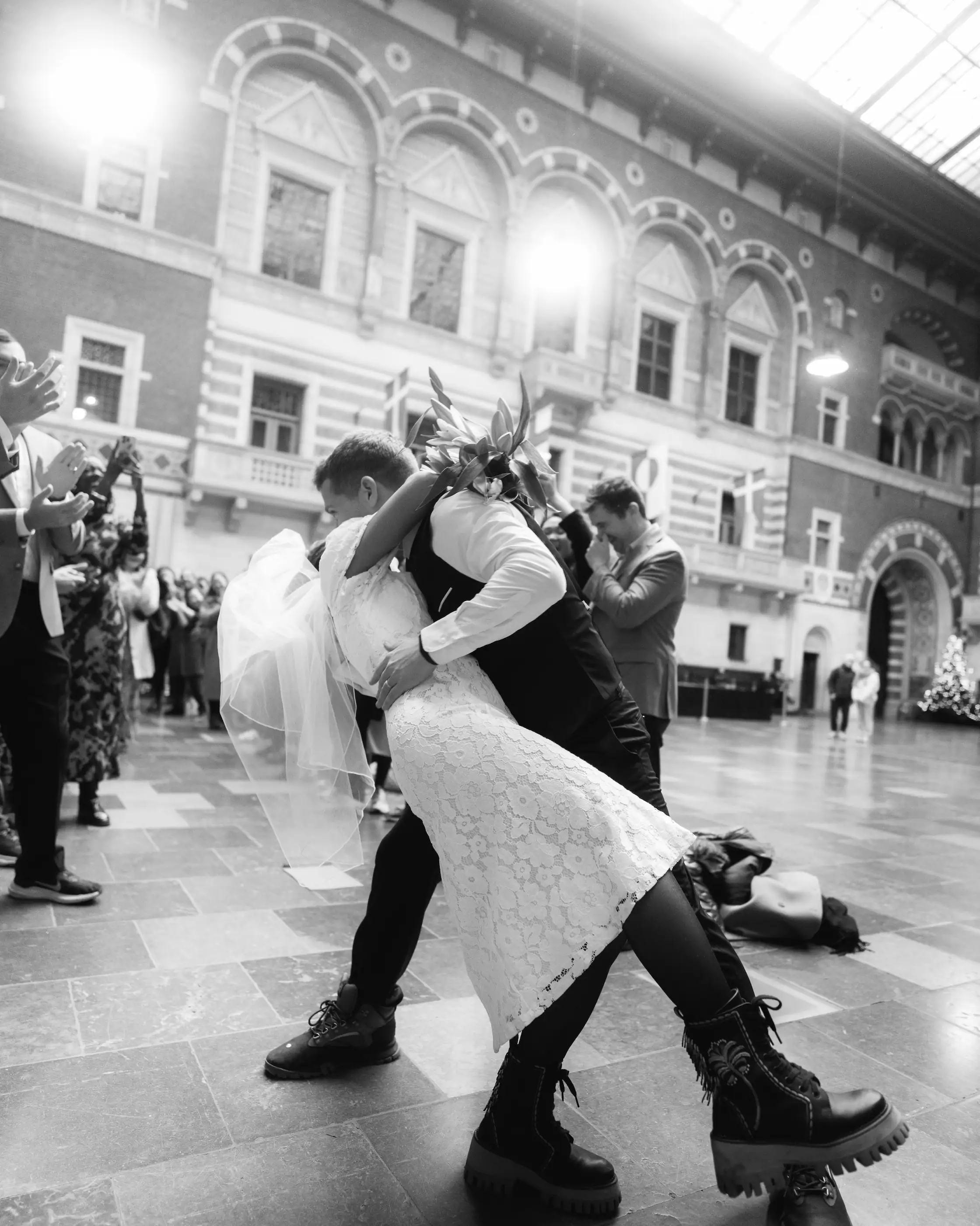 Bride and groom embrace in a kiss at the dance floor