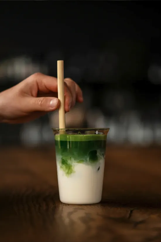 Whisked matcha latte in a dark cafe setting