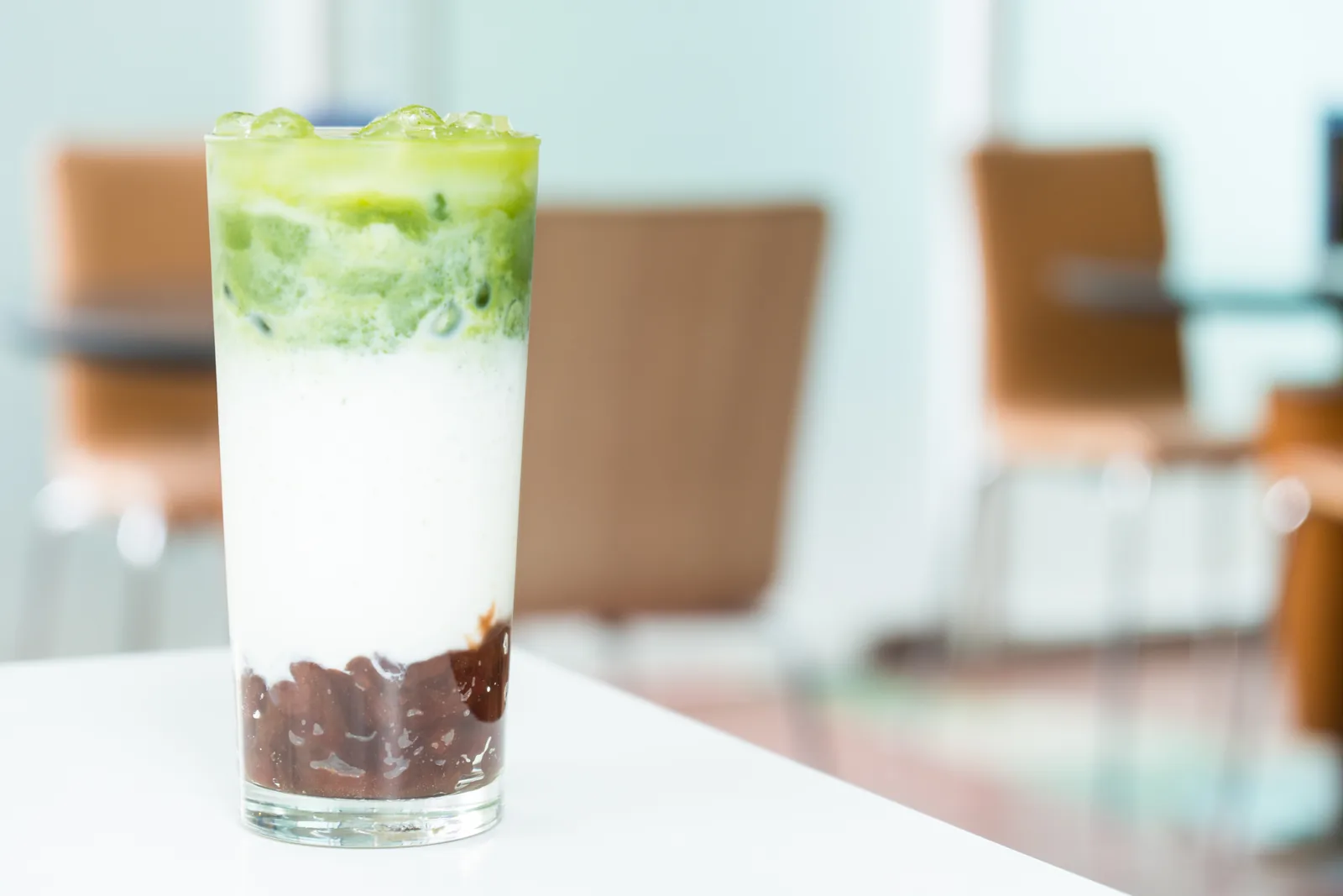 An iced matcha latte in a clear glass.