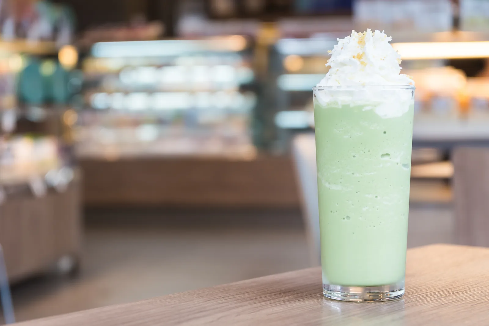 A blended green tea drink in a glass.