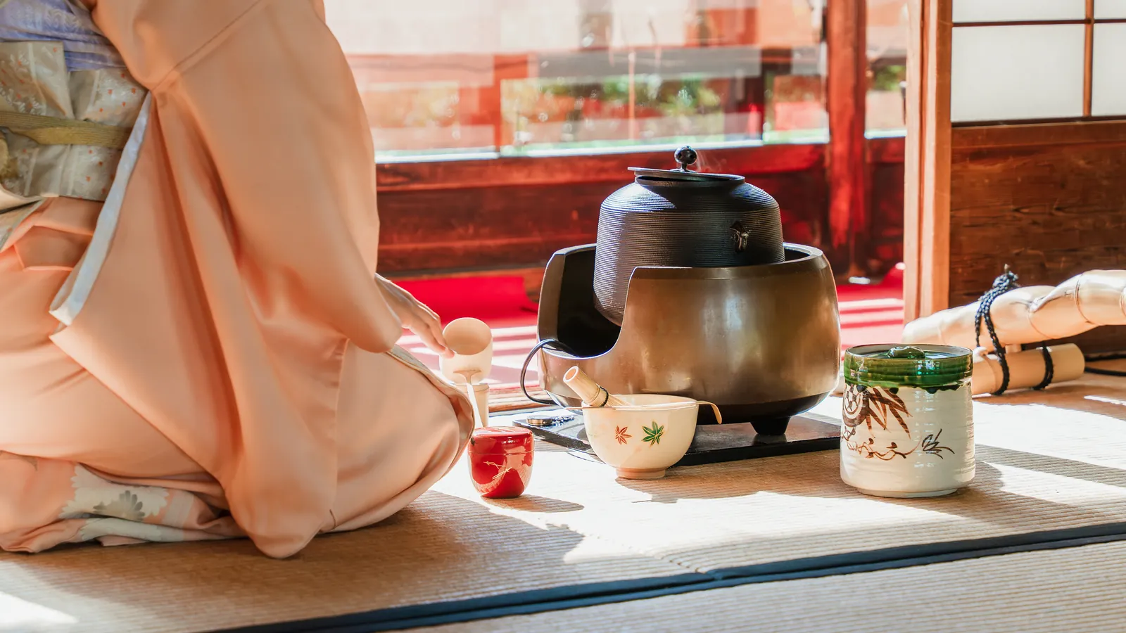 Powdered tea prepared with traditional utensils on a tatami floor