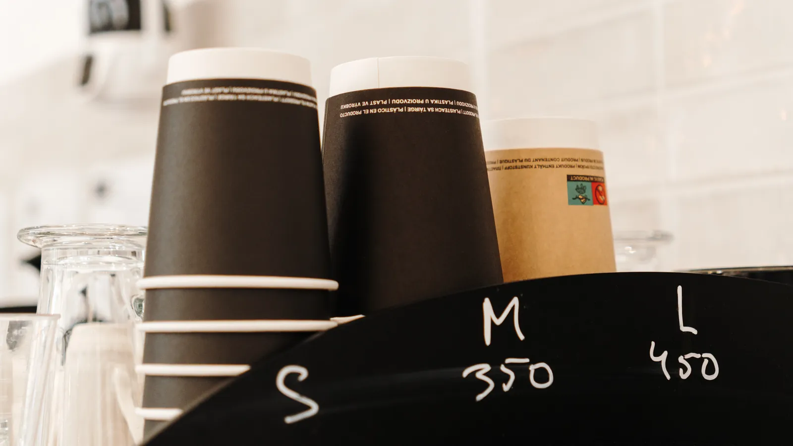 Takeaway cups stacked and sized on a cafe counter
