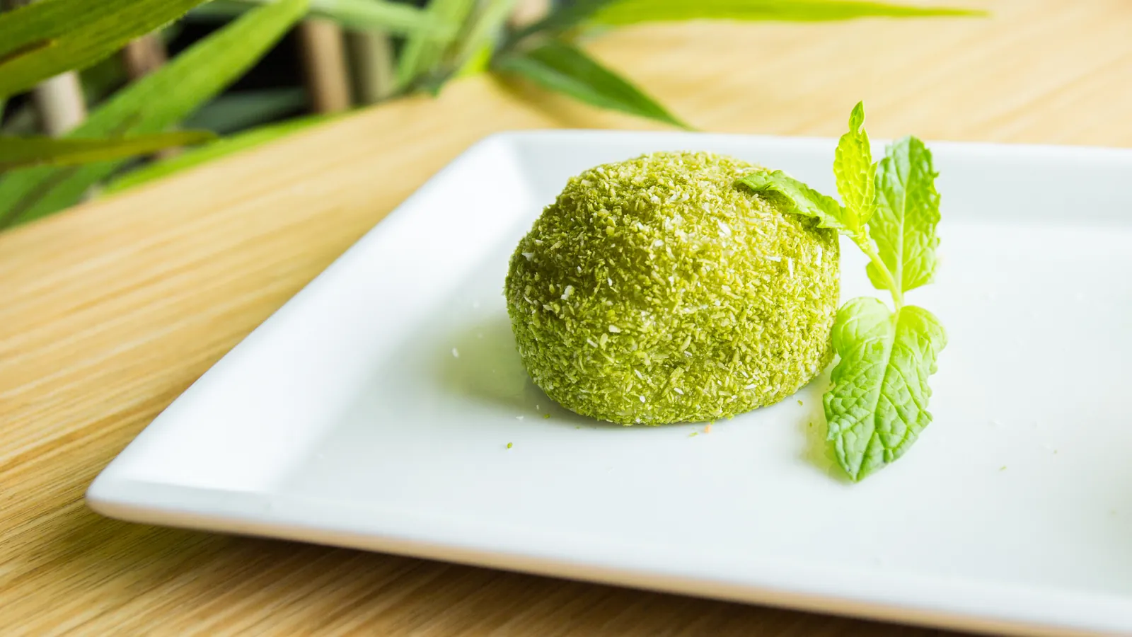 A matcha dusted Japanese sweet served on a plate