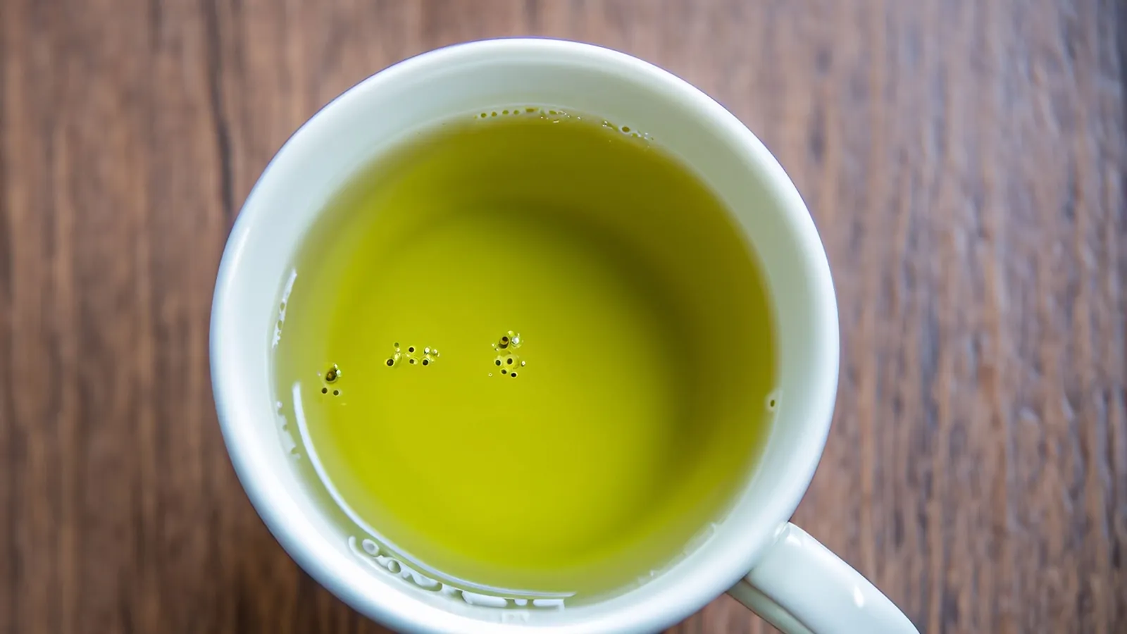 A cup of brewed green tea on a table
