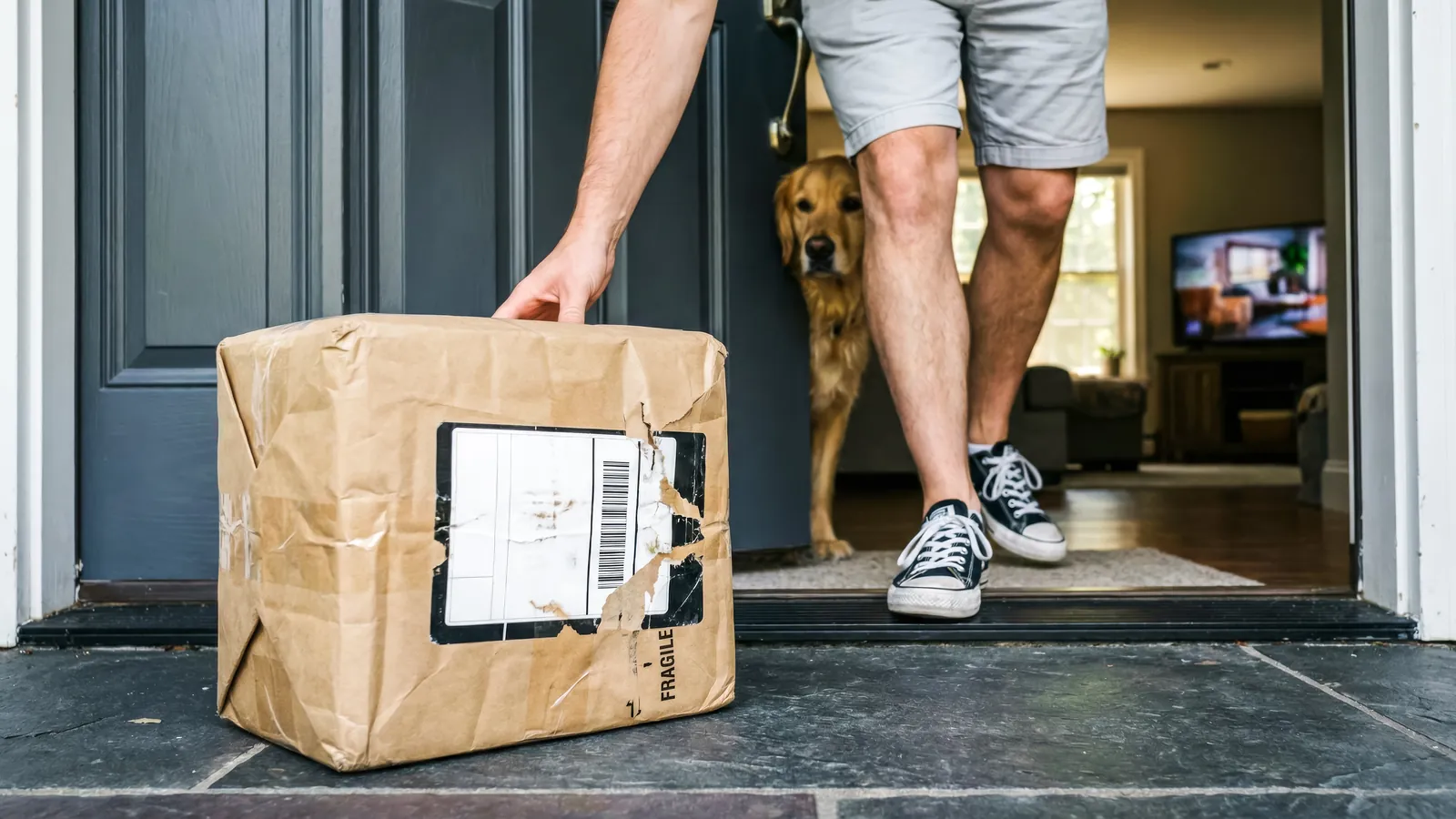 A labelled parcel being collected at a doorway