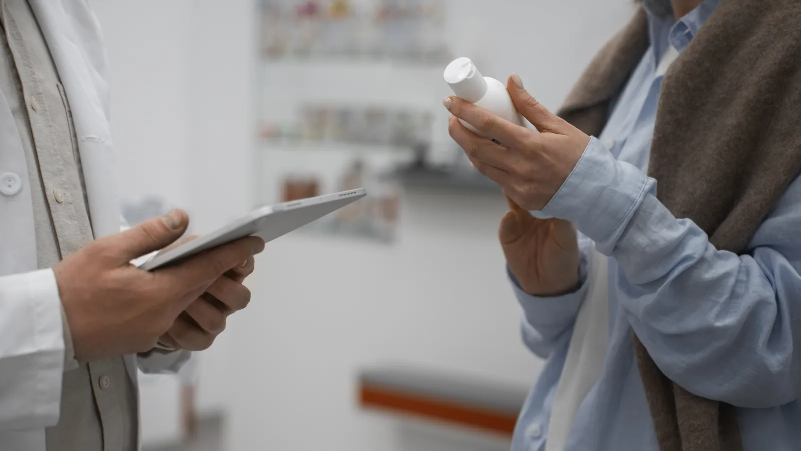 A pharmacist talking a customer through a product