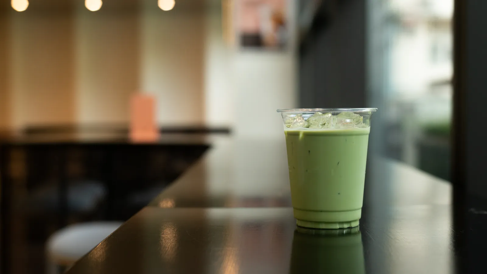 An iced matcha latte served on a cafe counter