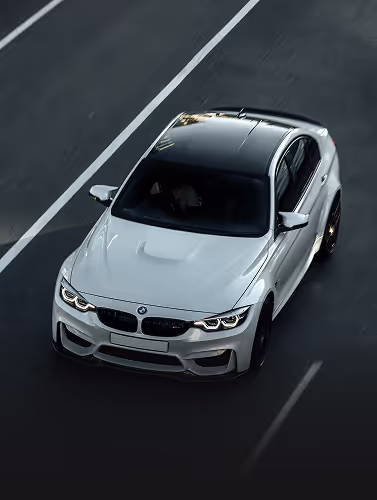 Luxury BMW car driving on a highway during a commercial film shoot
