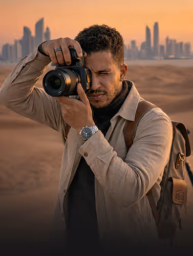 Professional photographer or cinematographer with a camera in a desert setting
