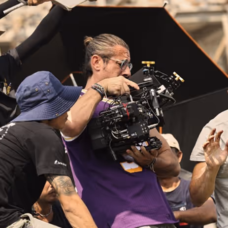 Film crew operating a professional cinema camera on an outdoor production set