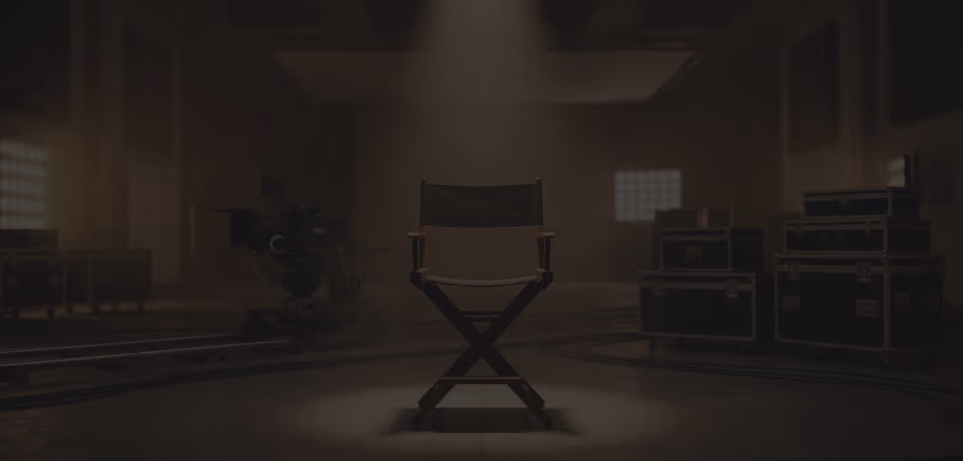 Director's chair illuminated by a spotlight in a dimly lit film production studio