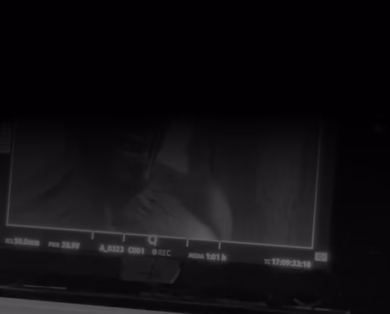Close-up of a film camera monitor displaying a scene during a night shoot on a professional video production set