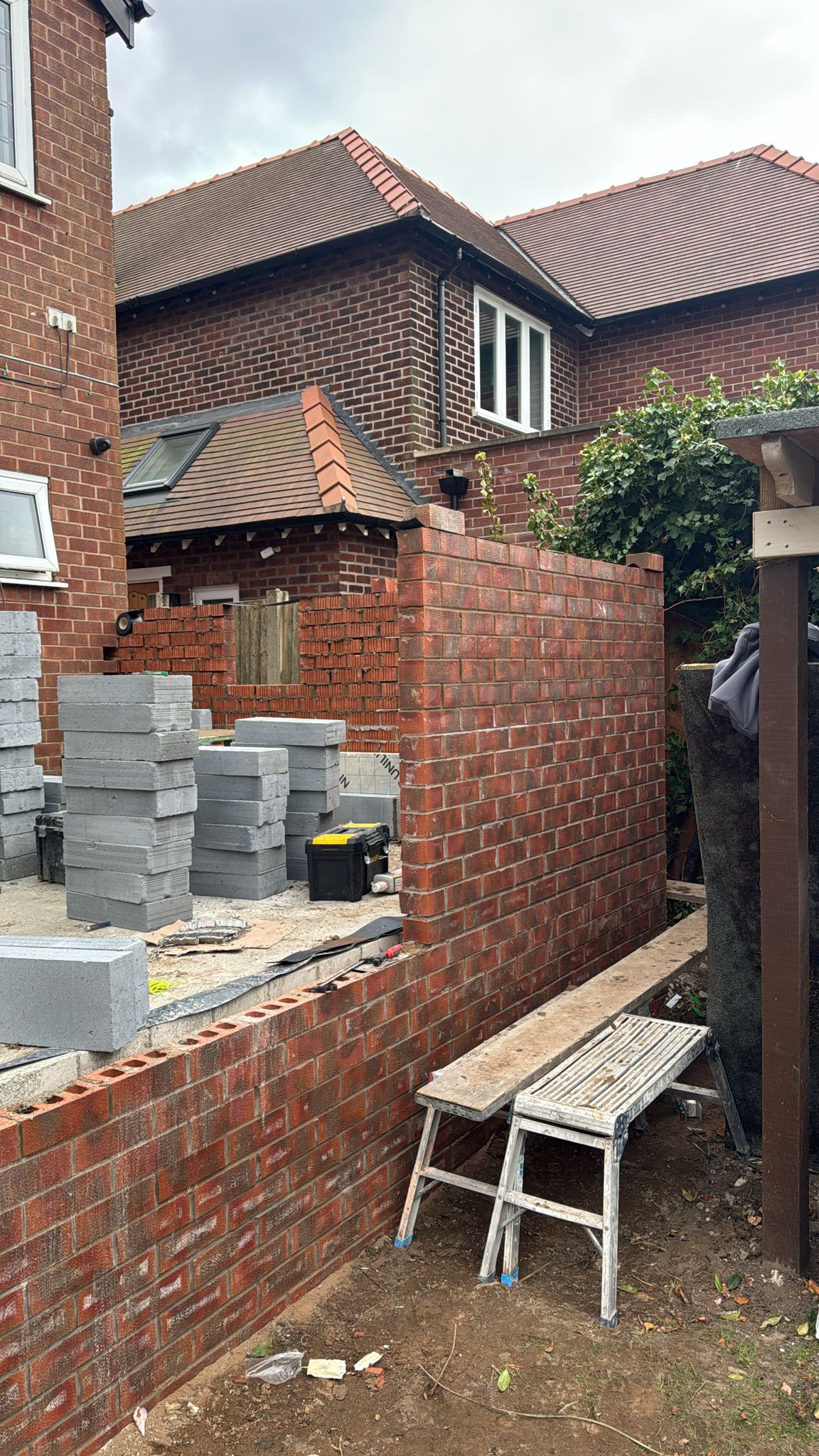Bricklayer building new garden wall and extension in Glossop