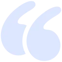 Blue quotation mark symbol on a white background.