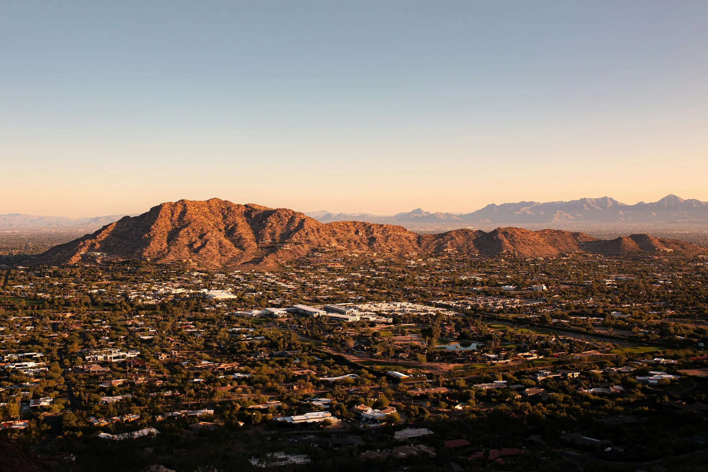 Aerial view of Phoenix, Arizona with mountains at sunset