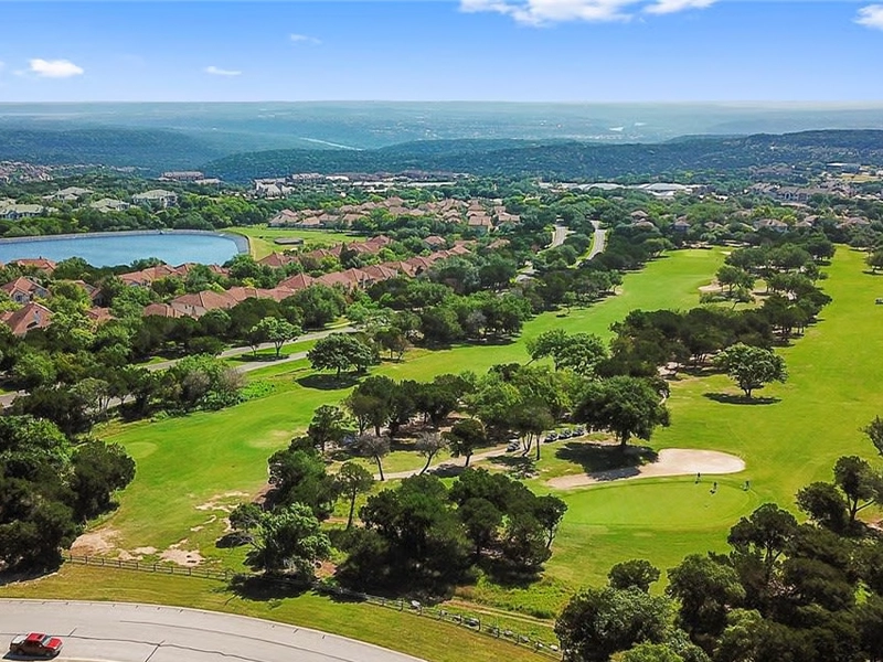 Bee Cave, TX Hill Country neighborhood with residential lawns.
