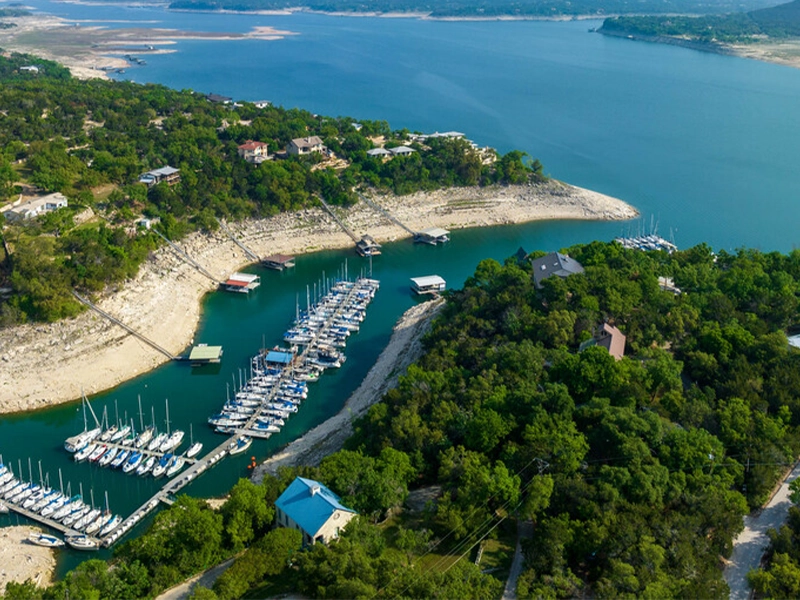 Lakeway, TX hillside neighborhood with residential lawns near Lake Travis.