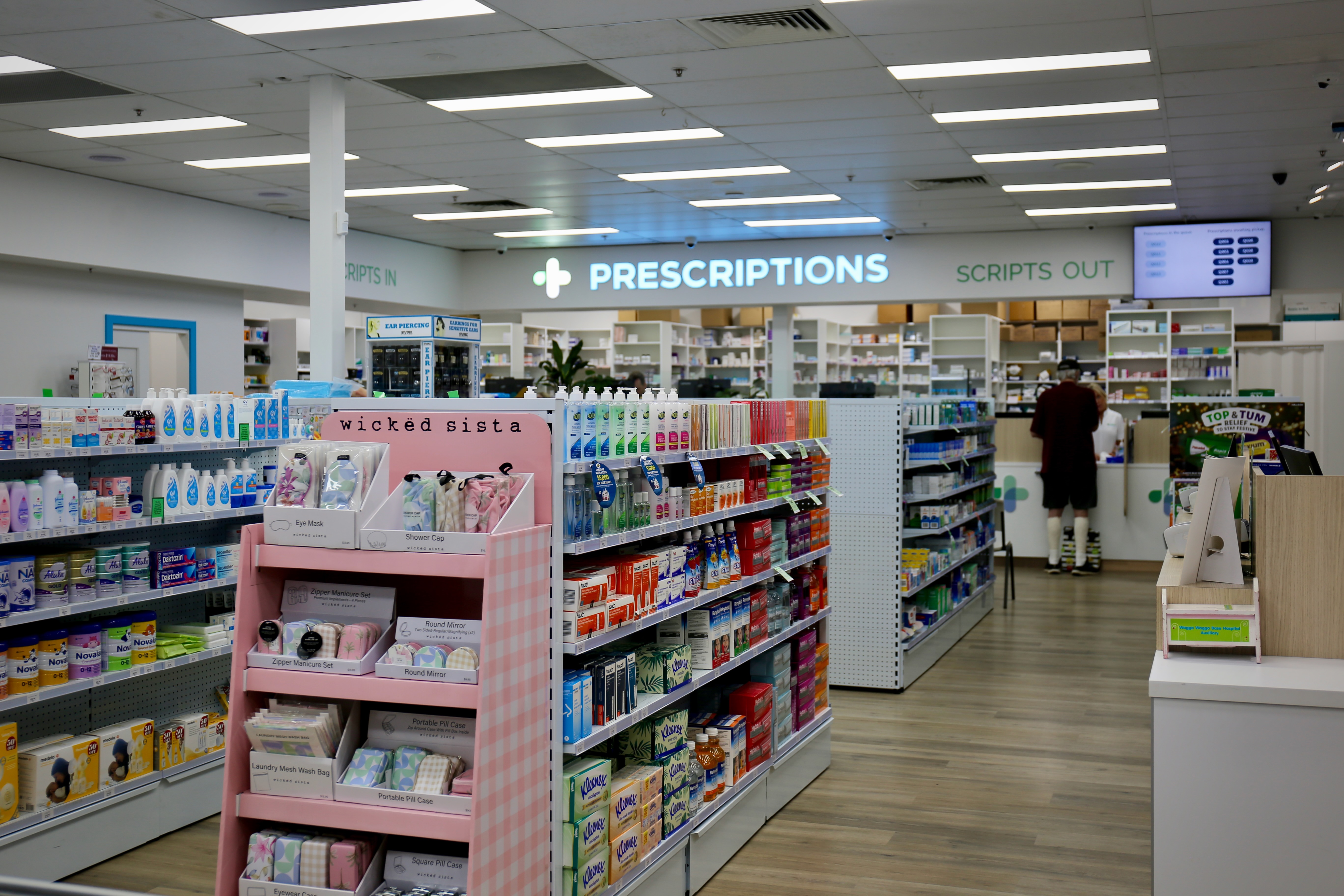 Pharmacy shelves stocked with vitamins and over-the-counter medicines
