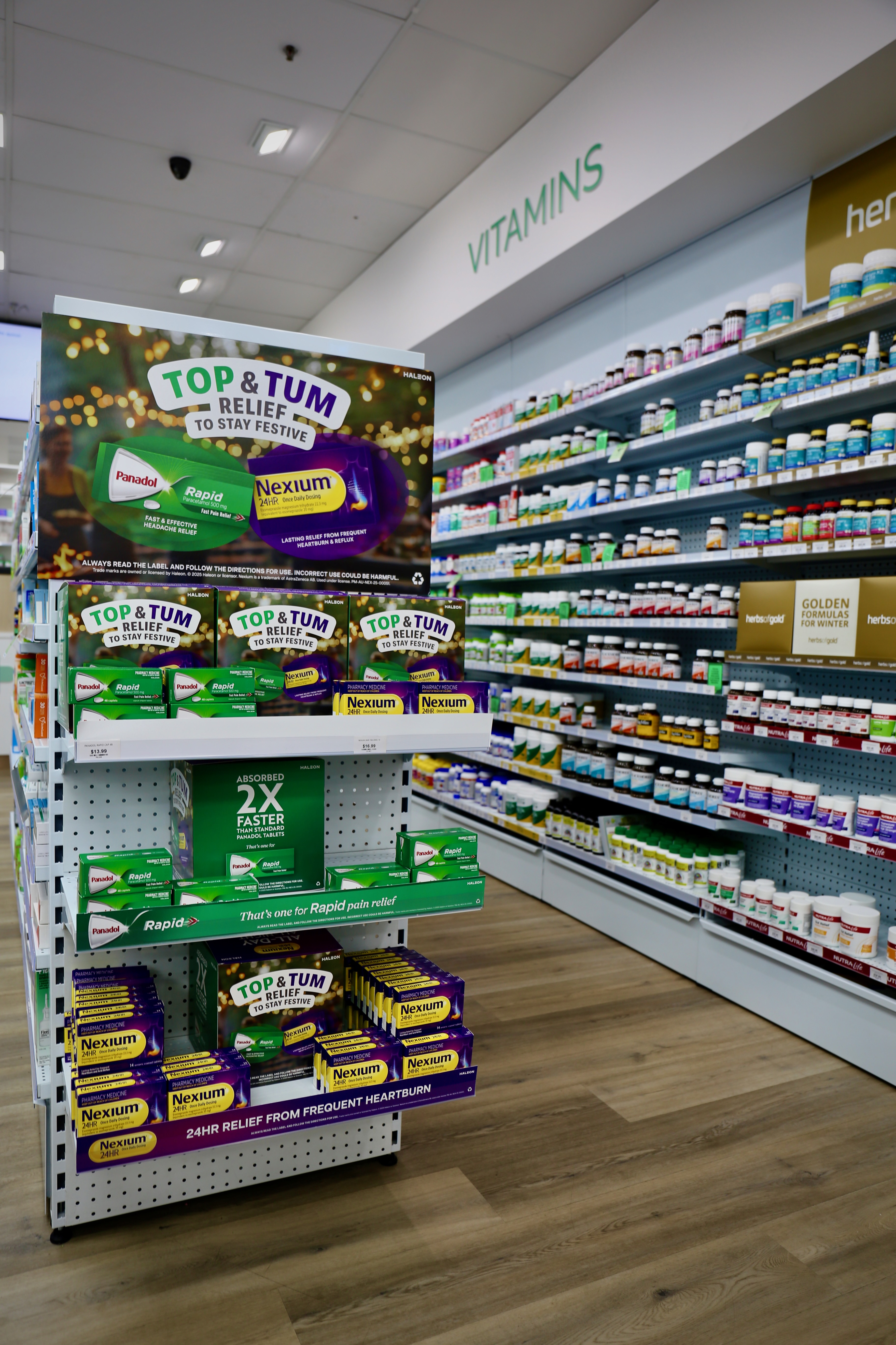 Pharmacy shelves stocked with vitamins and over-the-counter medicines