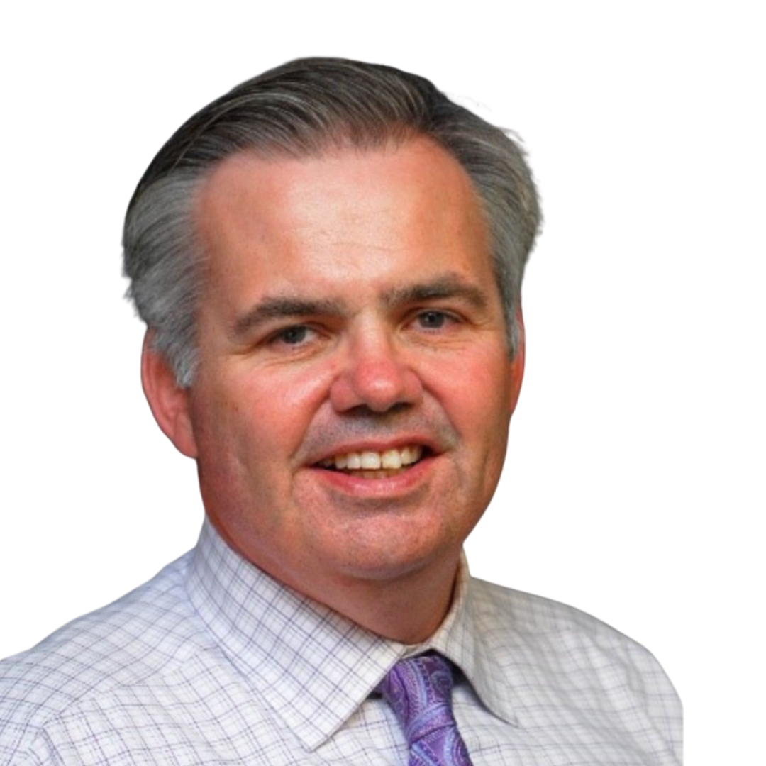 Middle-aged man with gray hair, wearing a checked dress shirt and purple patterned tie, smiling.