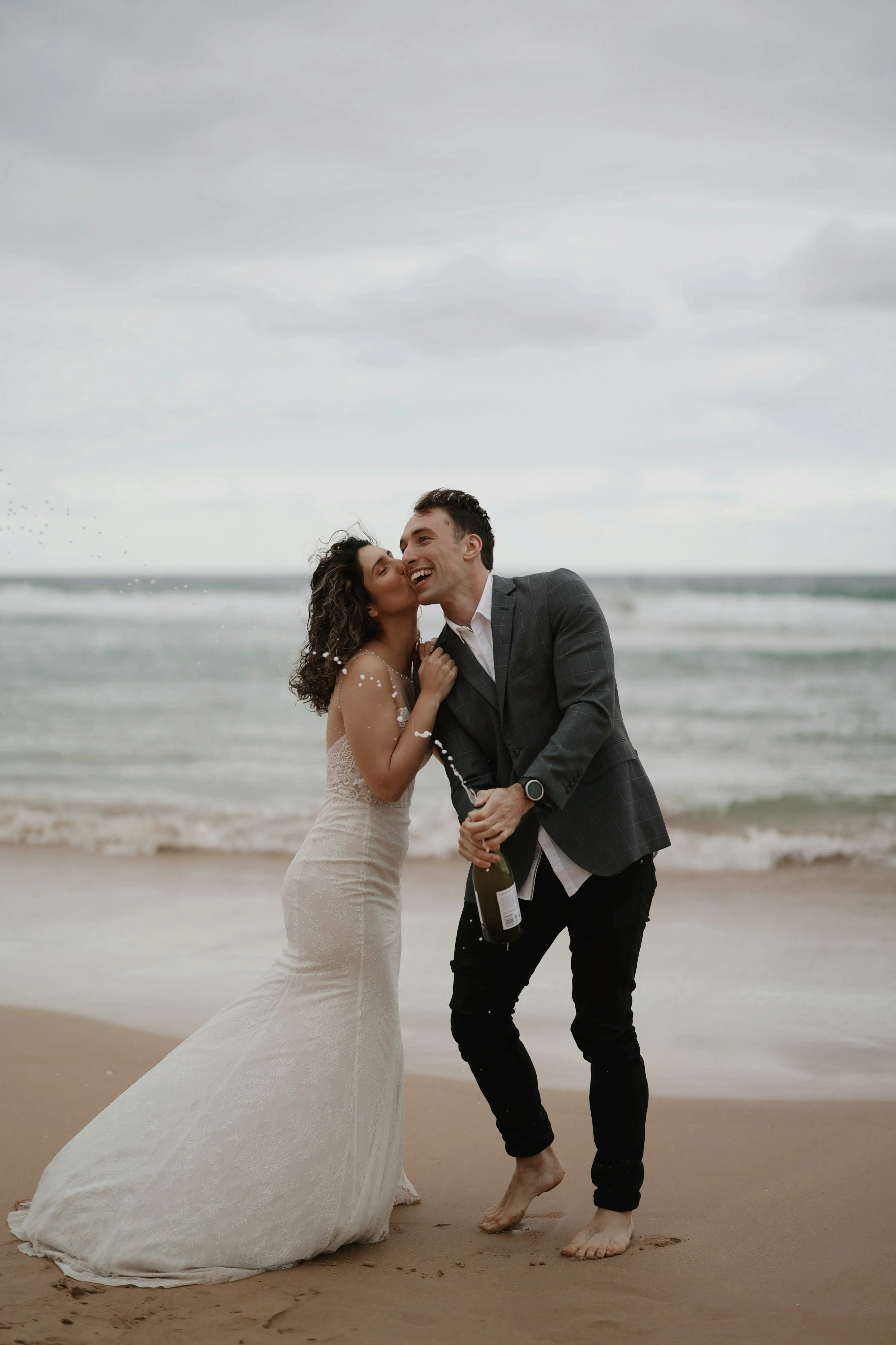 Un couple heureux célébrant leur mariage sur une plage paisible, partageant un moment de bonheur intime avec un bocal