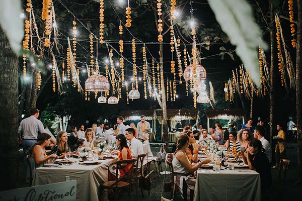 Dîner romantique en plein air à Bali sous des décorations suspendues et une lumière tamisée et chaleureuse.