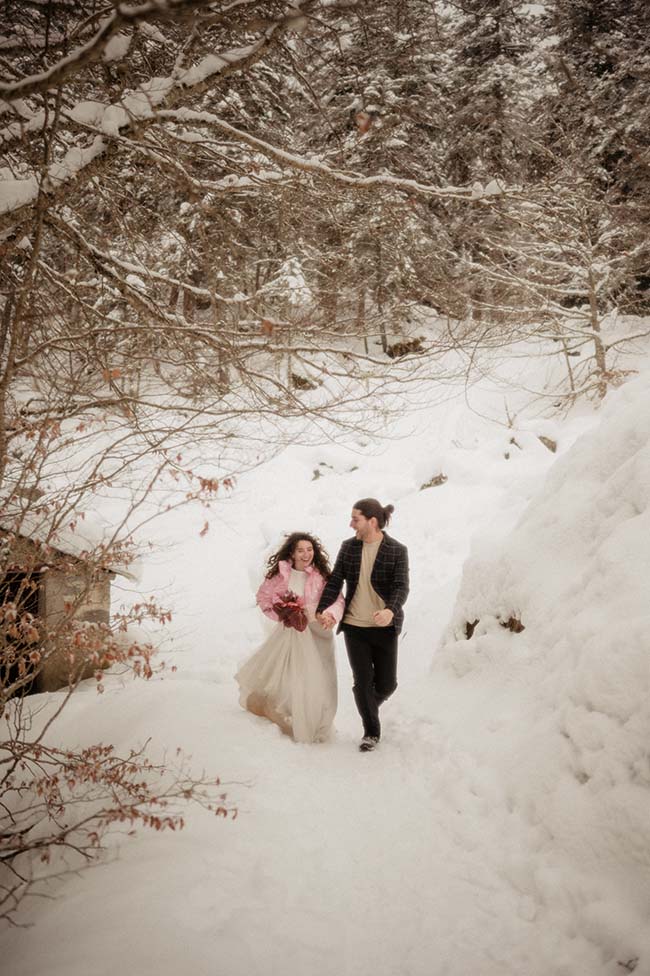 Un couple éblouissant dans des vêtements de mariage tendres contre un décor de neige immaculée.