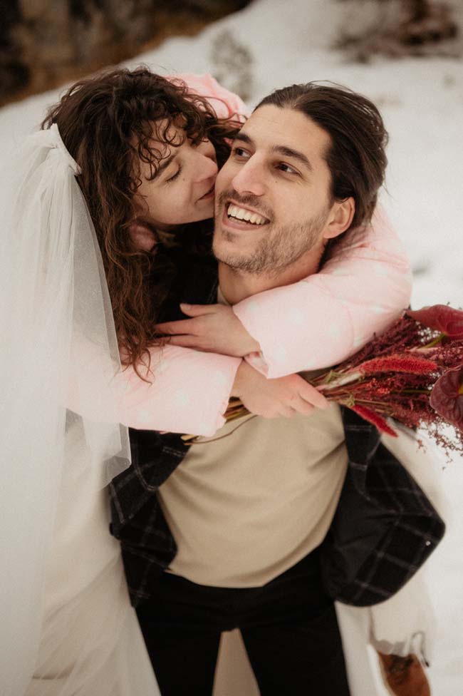 Une mariée en doudoune rose tendresse et un mari éblouissant dans une ambiance romantique enneigée.