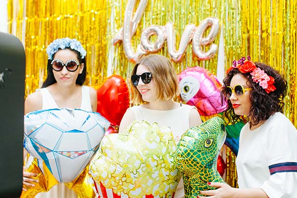 Un photobooth vibrante avec des décorations colorées et des ballons, offrant un instantané joyeux pour les mariés et