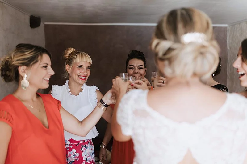 Une mariée et ses demoiselles d'honneur portent un toast joyeux avec des coupes de champagne.