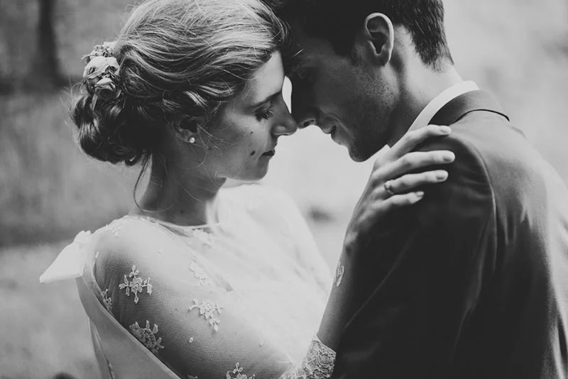 Portrait en noir et blanc de Charlotte et Julien, front contre front, dans une ambiance romantique et intimiste.