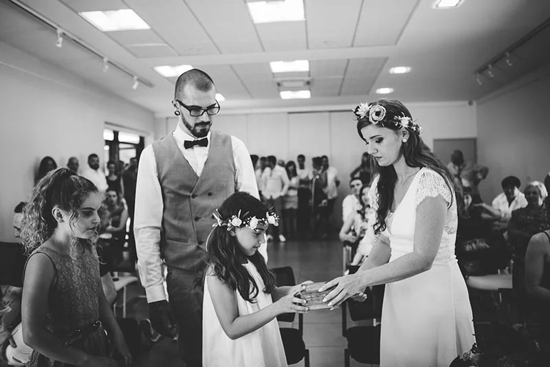 Photo noir et blanc de Virginie et Stéphane avec une petite fille lors d'une cérémonie de mariage.