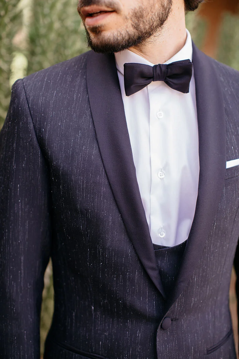 Élegance raffinée et discrète avec un costume de mariage fantaisiste en soie noire parsemé de perles.