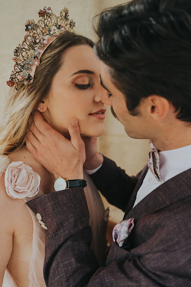 Un couple romantique à l'heure du mariage, vêus élégamment, partageant un moment tendre.