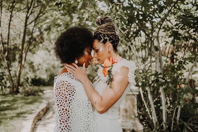 Une scène intime et romantique d'un couple en mariée et en mari, échangant des sentiments dans un parc luxuriant.