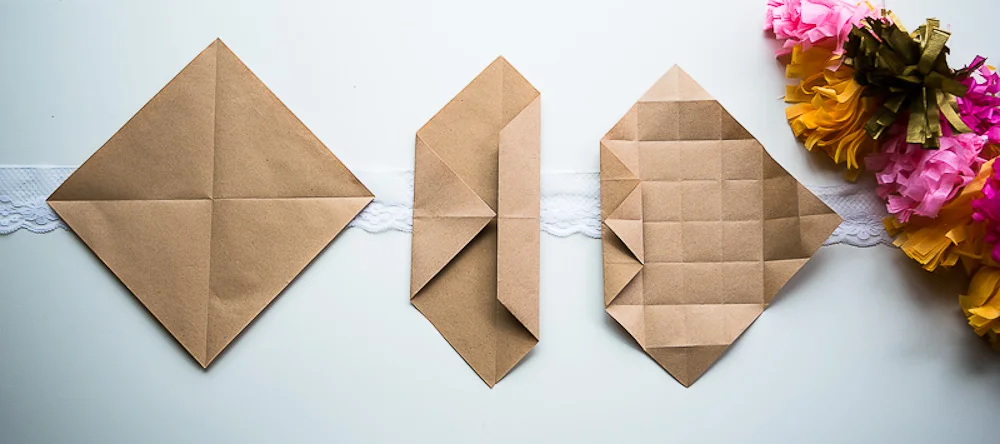 Trois étapes de pliage de boîtes en papier kraft sur un fond blanc avec dentelle et pompons colorés.