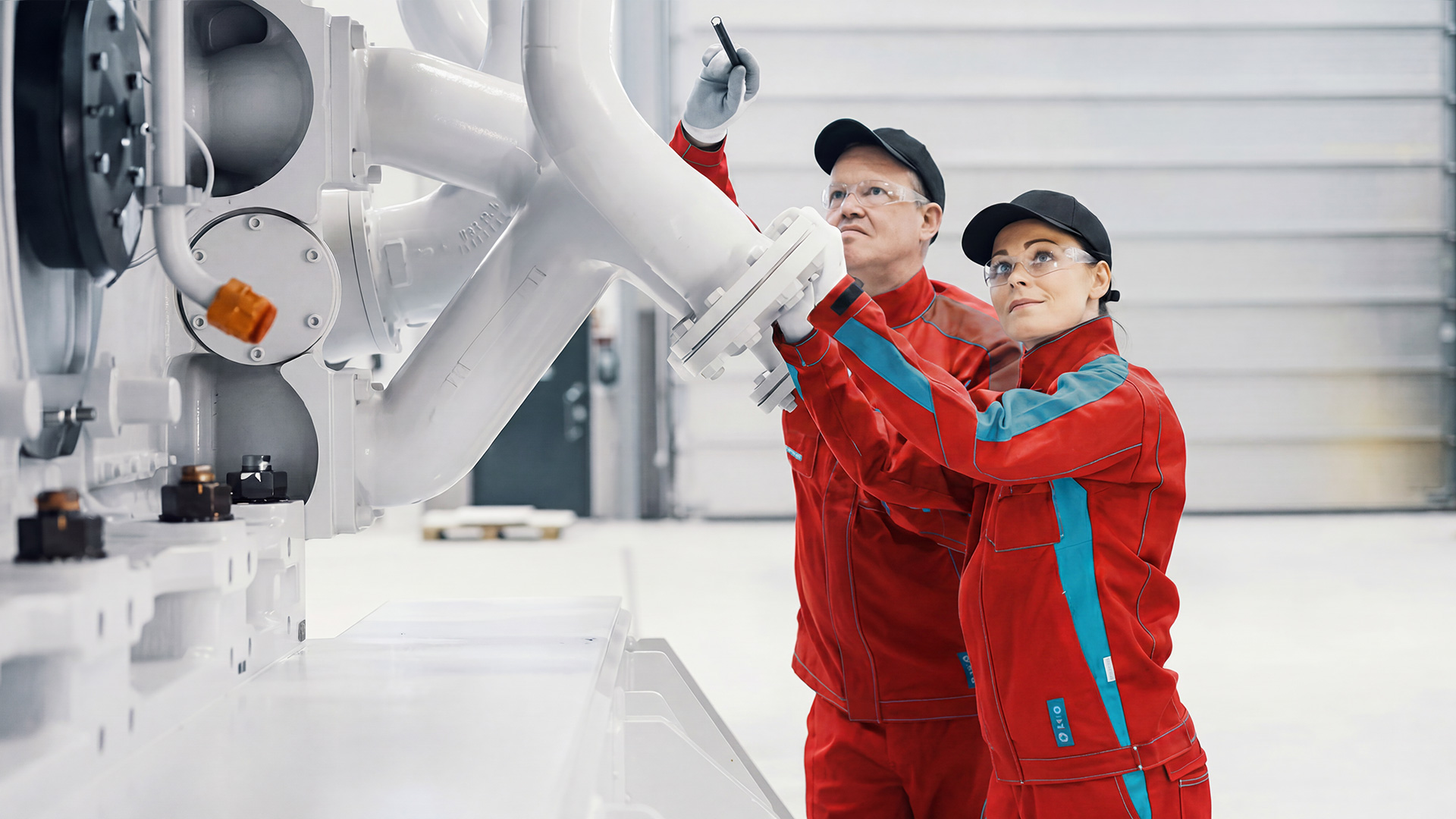 Marine service engineers inspecting and maintaining industrial vessel equipment during system support operations.