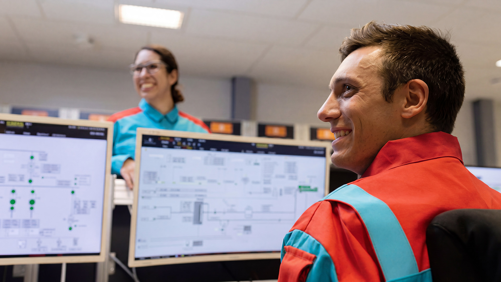 Technical support team monitoring and managing marine systems from a control room environment.