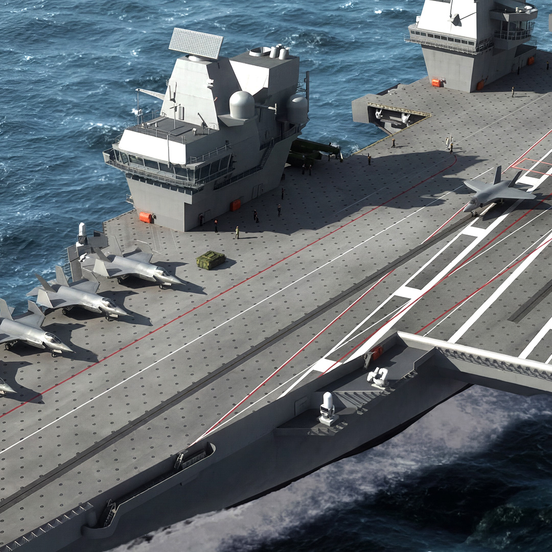 HMS Queen Elizabeth aircraft carrier sailing at sea with fighter jets on deck.