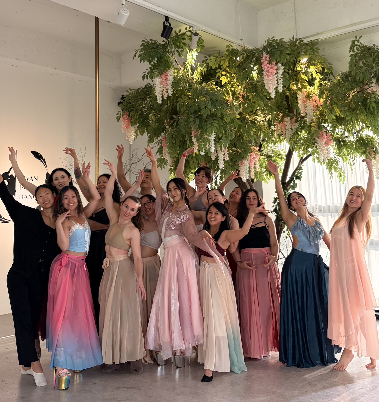 K-Pole Retreat group photo with participants wearing colorful dresses after having finished a tango pole workshop at Swan Studio in Seoul.